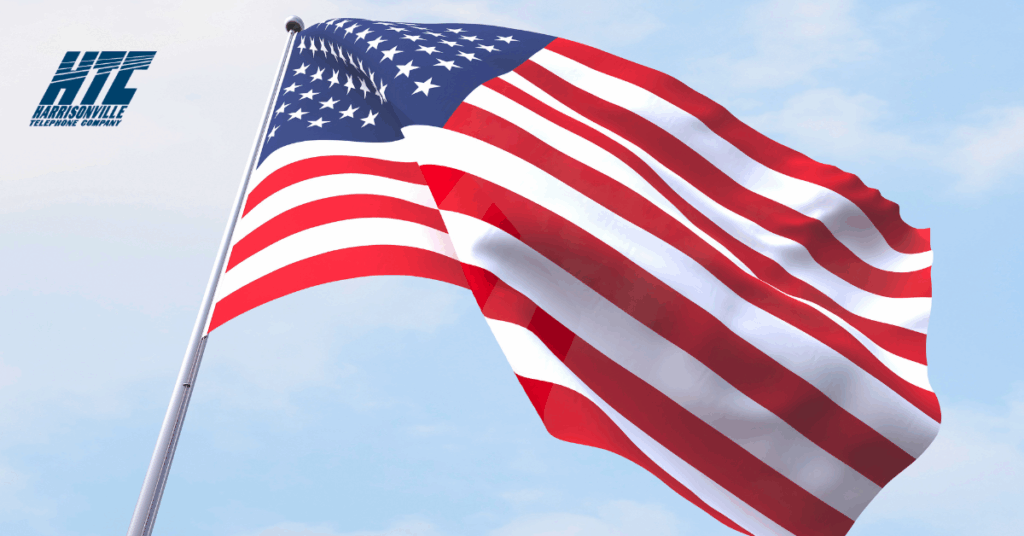 Image of an American flag flying against a blue sky as the blog header for a blog about how to celebrate America's 250th birthday in Monroe County, IL