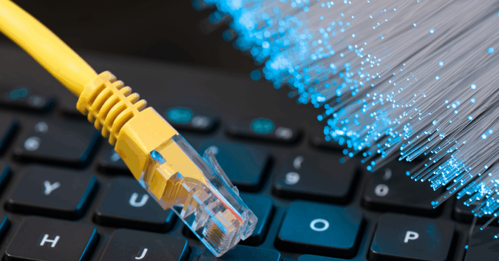 An image showing a keyboard along with wired Internet and fiber-optic cables, showing the difference between Hybrid and Fiber-to-the-Home options