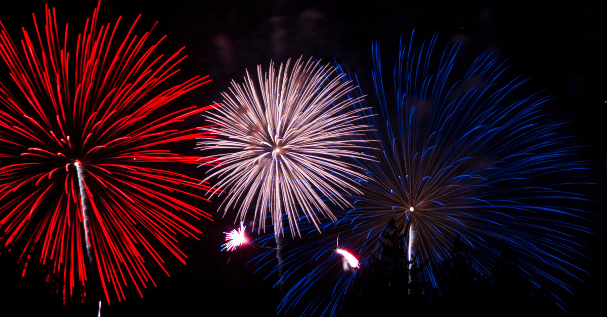 Fourth-of-July-Celebrations Fourth of July fireworks in the colors of red, white, and blue burst in the night sky.