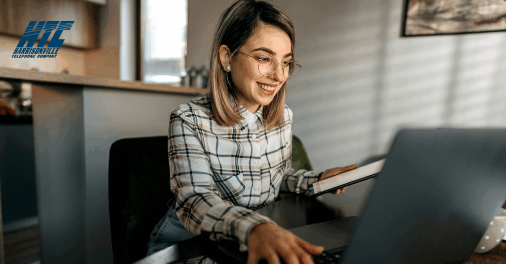 Woman sits at a computer in her home using the best technology to access the Internet