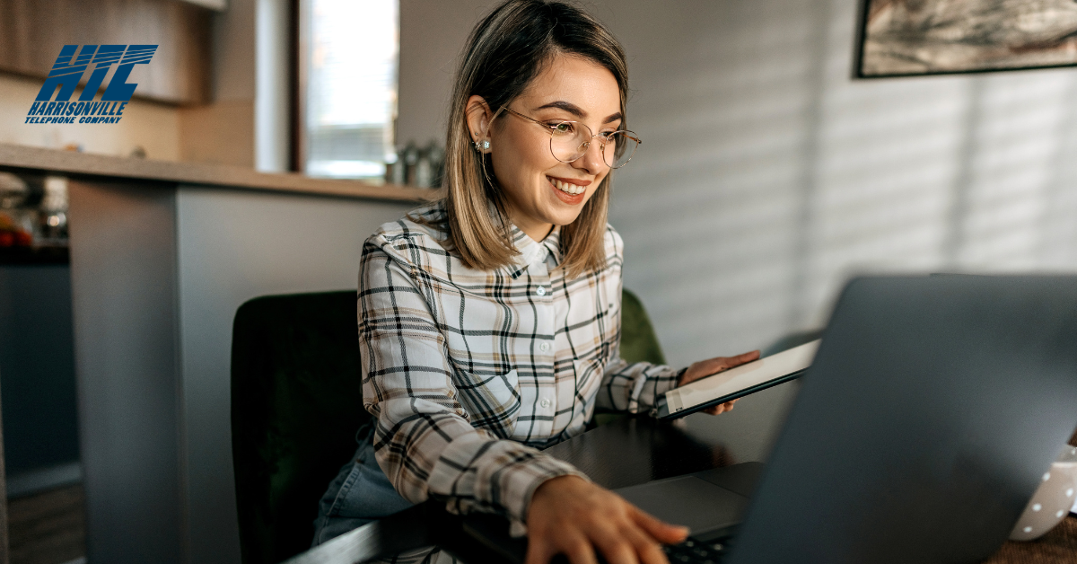 Woman sits at a computer in her home using the best technology to access the Internet