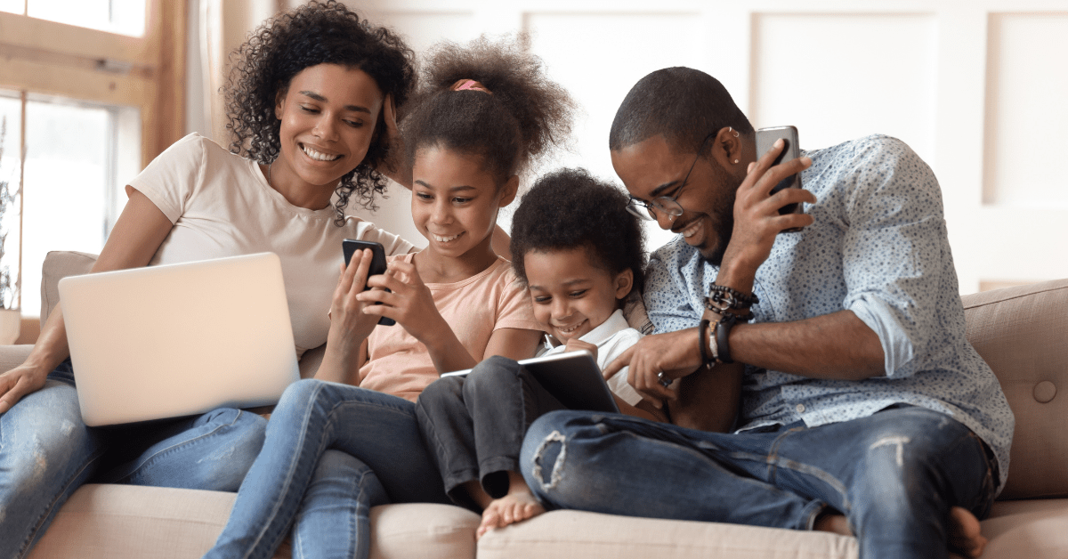 Blog header image for a blog about internet bundles on a budget, showing a family sitting on a couch together while each uses a different device connected to the internet.