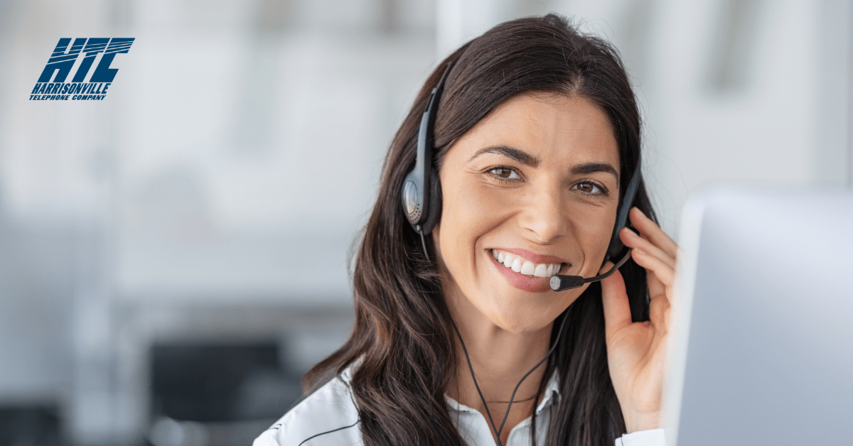 Blog header showing a top-rated customer service professional sitting at a computer and using a headset