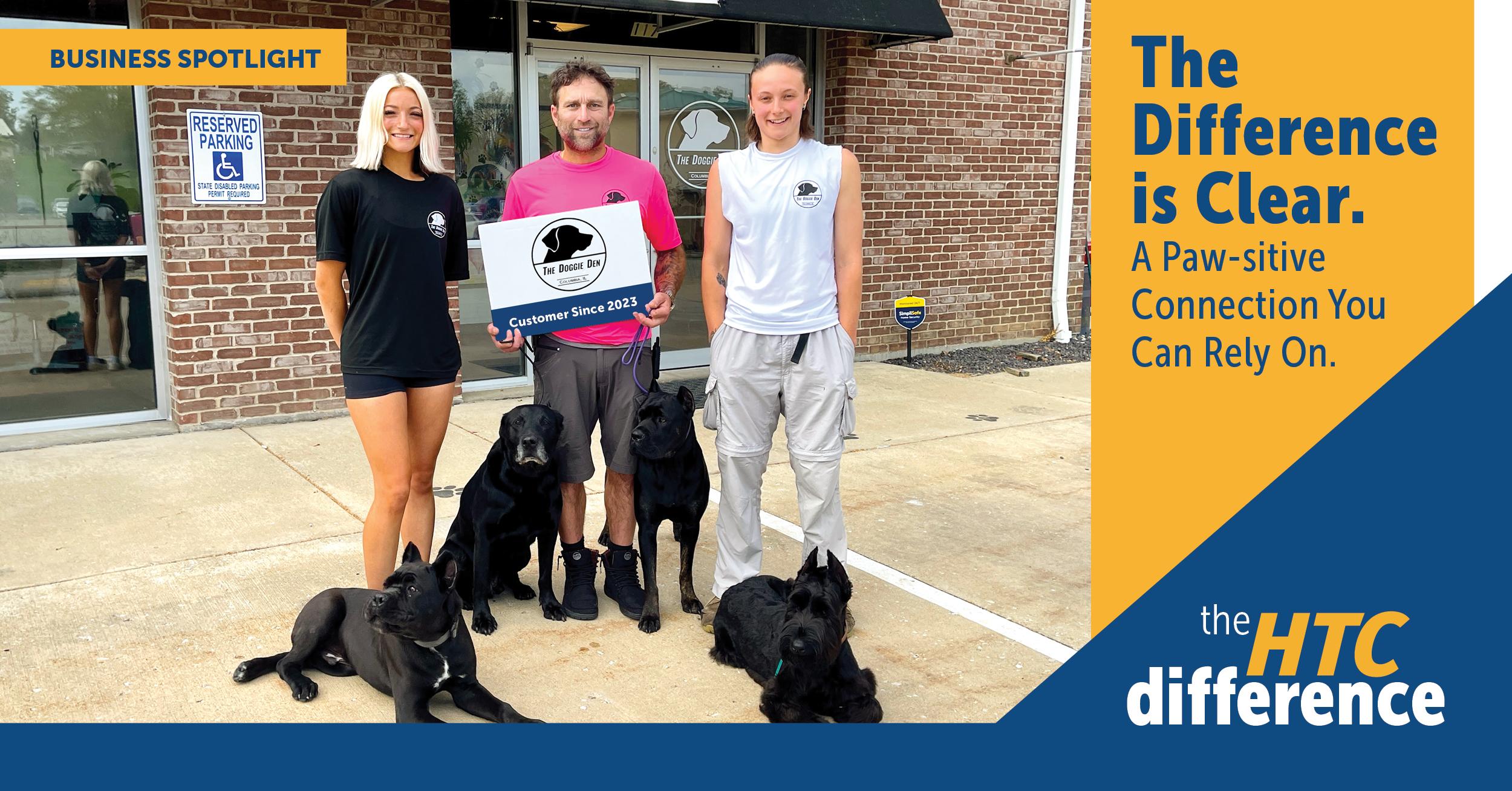 Image showing The Doggie Den team holding their logo, plus five dogs from The Doggie Den