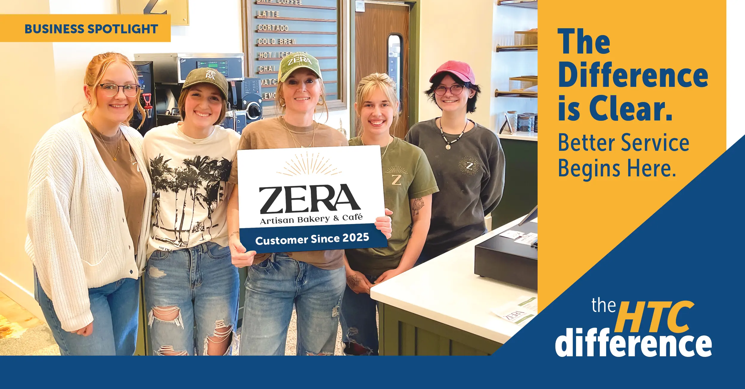 The team at Zera Artisan Bakery poses in their new business with a sign that reads Zera Artisan Bakery - Customers Since 2025.