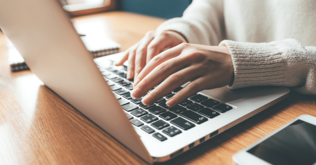 Person typing on a laptop after making the switch to HTC Internet